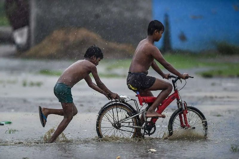 Children play on a waterlogged road after heavy monsoon rains in Ghaziabad, Wednesday, Aug. 19, 2020. (PTI Photo/Arun Sharma)